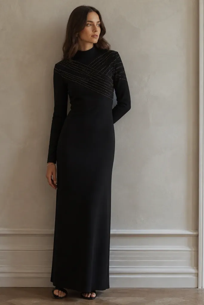 Model in a black long-sleeve mock-neck dress with subtle metallic threading lines across the bodice; straight skirt to the ankles.